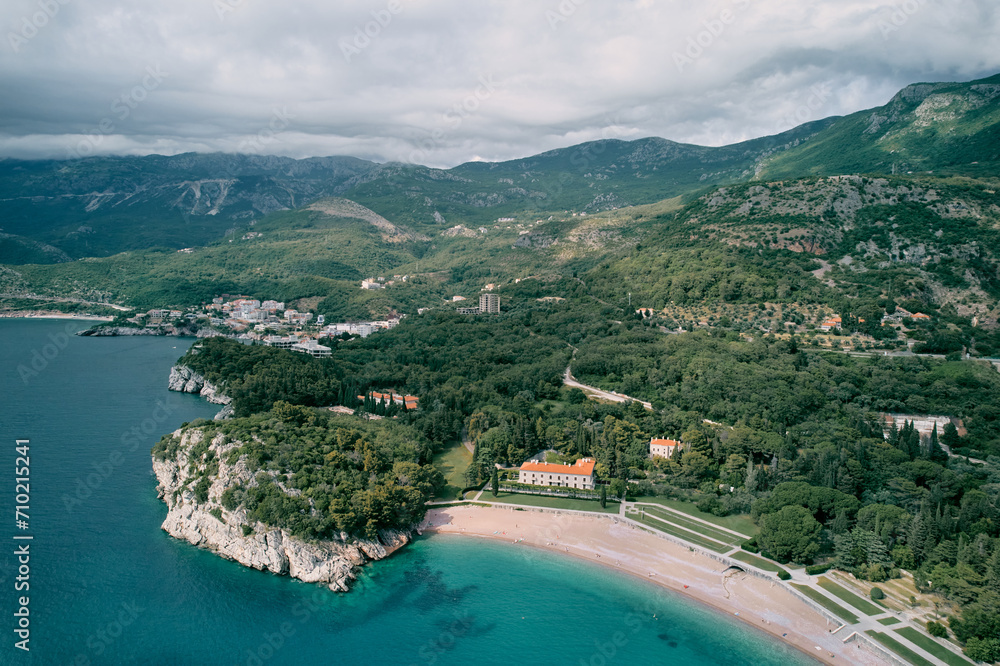Beach and green park near Villa Milocer at the foot of the mountains. Montenegro. Top view