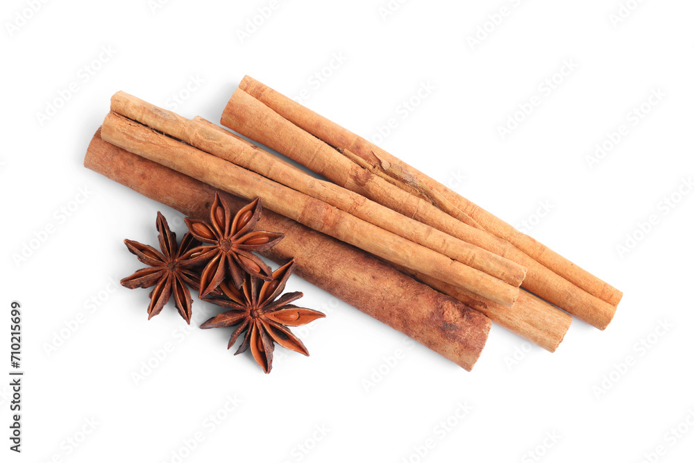 Aromatic cinnamon sticks and anise stars isolated on white, top view