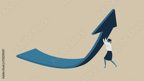 Businesswoman holding up an arrow.