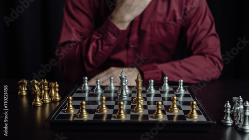 Close up of chess game with hands analyzing new strategy plan, teamwork concept, hands of businessman moving chess pieces in successful competition. Management strategy or leadership concept