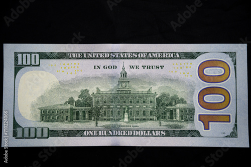 back of the 100 US dollar note on a dark background