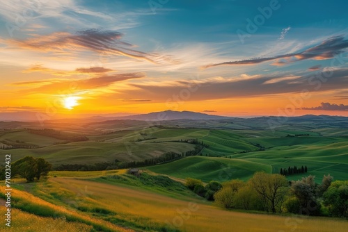 A panoramic landscape of rolling hills Picturesque countryside And a vibrant sunset © Jelena