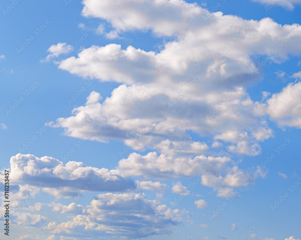 Obraz premium Blue sky with white clouds, tranquil blue trend color, pastel colored cloudscape. Fluffy heaven pattern. Beautiful Cloudy background, nature environment backdrop, wallpaper, screensaver