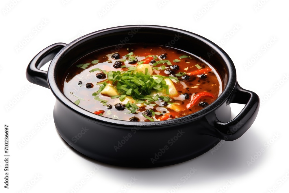 High quality photo of hot soup in a black pot on a white background