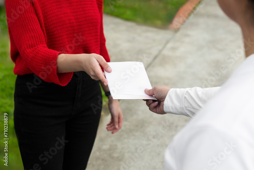 Hands Exchanging a Blank Leaflet