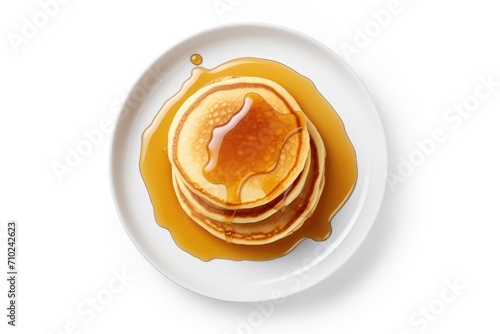 Pancakes and maple syrup on white background from above photo