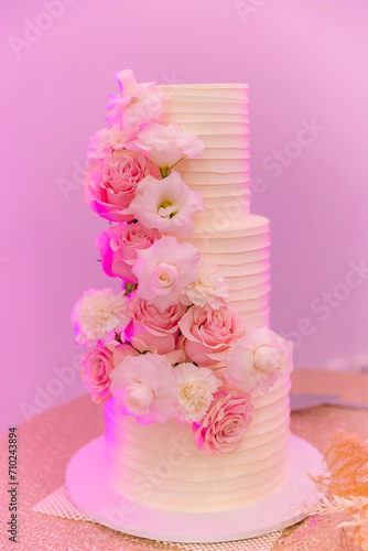 Beautiful white wedding cake decorated with flowers 