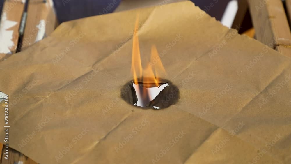 Parson Paper Fire Burning brown paper burning from center hole fire Stock Video | Adobe Stock