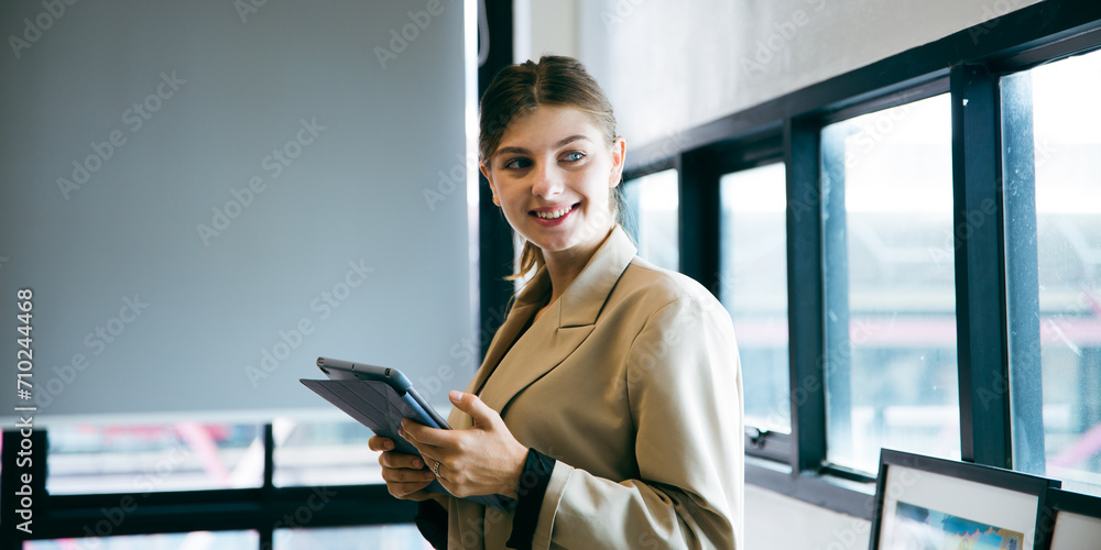 Fototapeta premium Confidence businesswoman female Caucasian manger is having a vision and ideas while working with digital tablet. Portrait of beautiful executive or employees work at company indoor office cyberspace