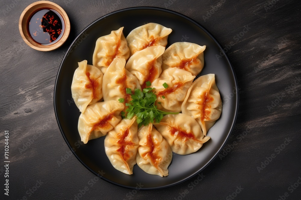 Top view of gyoza on a plate placed on a gray concrete surface