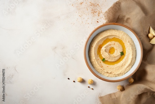 Top view of hummus on a light table in the kitchen photo