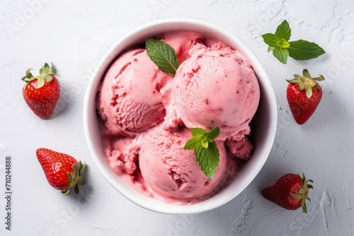 Top view of strawberry ice cream in bowl on white stone background photo