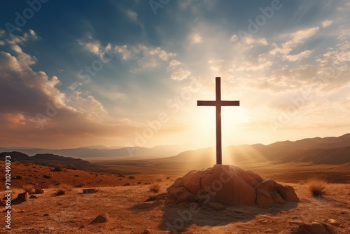 Christian cross on desert with sunrise background photo