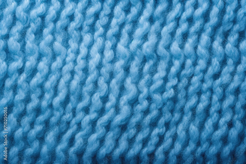 Close up of blue knitted fabric with a textured pattern made of angora or wool Close up of blue knitted fabric with a textured pattern made of angora or wool