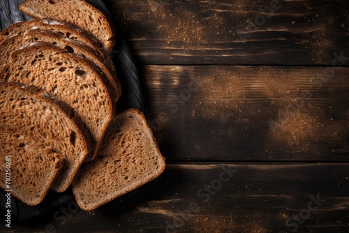 Closeup of sliced wholegrain bread on rustic wooden background seen from above