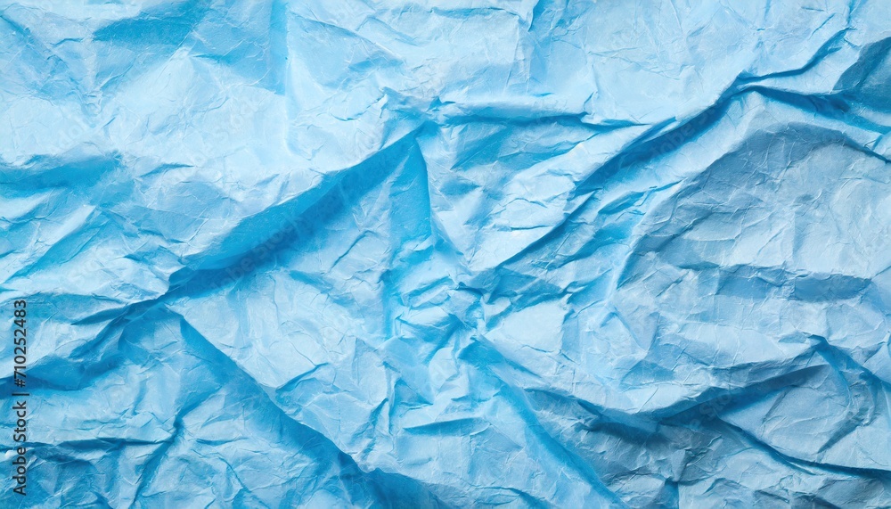 Obraz premium The blue crumpled paper background.