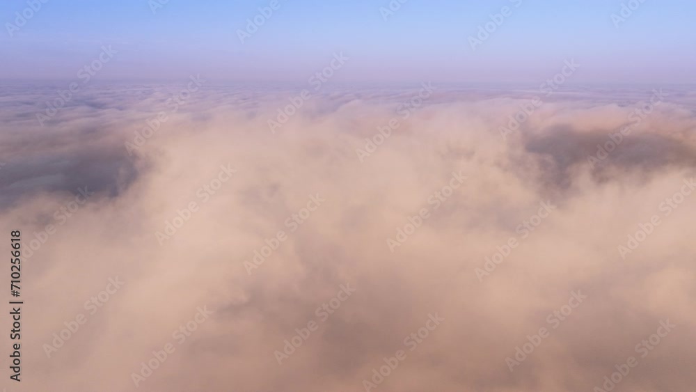 Epic hyperlapse drone flying through paradise cloudscape at sunrise or sunset. Time lapse above beautiful clouds. Camera moves straight into pastel pink, peach clouds swirling fast under blue sky 4K Epic hyperlapse drone flying through paradise cloudscape at sunrise or sunset. Time lapse above beautiful clouds. Camera moves straight into pastel pink, peach clouds swirling fast under blue sky 4K