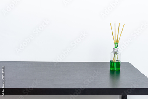 Black table with air freshener and white background. Copy space. photo