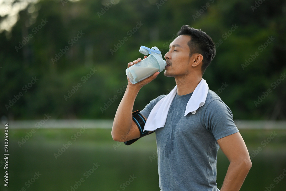 Portrait of sportsman drinking a protein and resting after jogging session in the morning Portrait of sportsman drinking a protein and resting after jogging session in the morning
