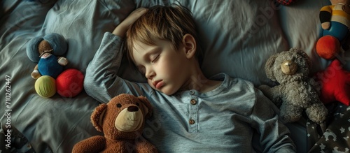 Child sleeping with playthings