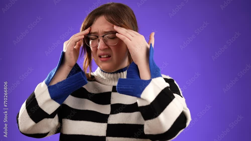 Portrait of sick tired headache migraine exhausted displeased pretty woman 20s posing isolated on purple background studio. Put hands on head rub temples Portrait of sick tired headache migraine exhausted displeased pretty woman 20s posing isolated on purple background studio. Put hands on head rub temples