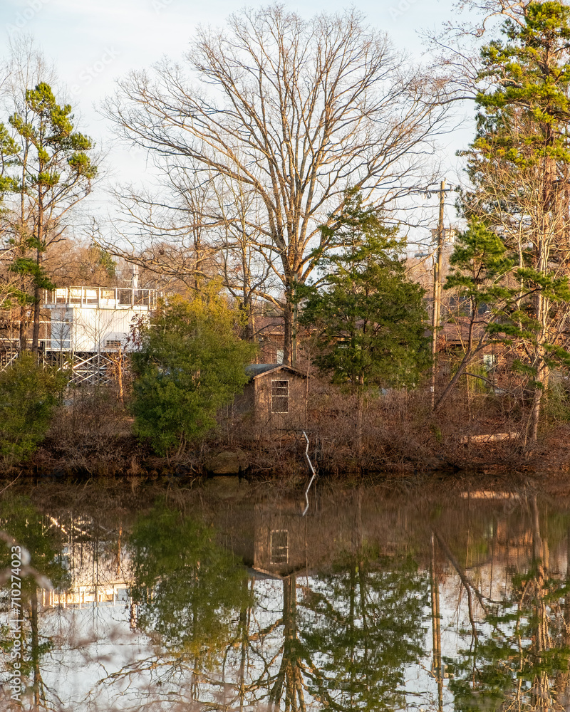 Shack and trees reflecting off of a pond in Charlotte, North Carolina.