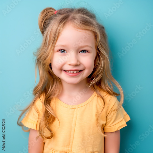 Portrait of a smiling little girl isolated on a color background