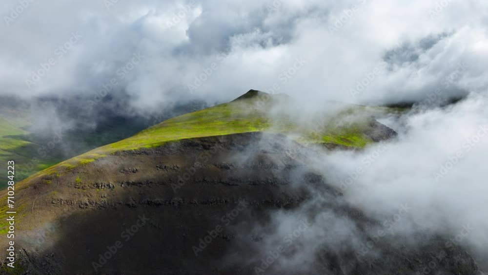 Flying Through Clouds Above Hills Cowered With Green Grass, Paradise Heaven Mountain Range With High Peaks, Wonderful Inspiring Natural Landscape. Iceland Nature. Flying Through Clouds Above Hills Cowered With Green Grass, Paradise Heaven Mountain Range With High Peaks, Wonderful Inspiring Natural Landscape. Iceland Nature.