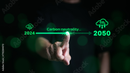 Carbon neutrality concept. Hand touching increasing arrow with carbon reduction for decrease CO2 or carbon neutral by 2050. Carbon footprint, Net Zero, Climate change, Global warming, CO2 emissions,