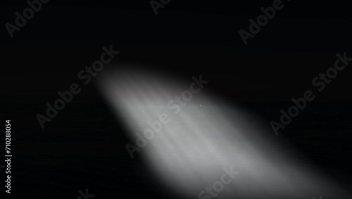 Simulation of ground spotlight on black background with particles fluctuating photo