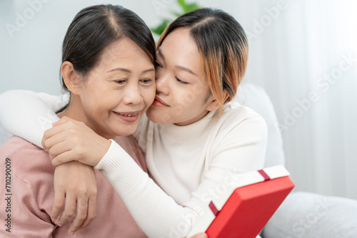 Mother day, cute asian teen girl hugging and kissing on the cheek, mature middle age mum. Love, kiss, care, happy smile enjoy family time. celebrate special occasion, happy birthday, merry Christmas.