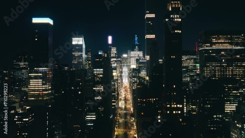 New York city night evening buildings downtown skyline. Skyscrapers finance district. Aerial flight over NYC downtown illuminated at night. Night traffic aerial.Big Apple cityscape at night drone shot photo