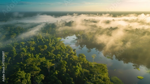 Aerial view of beautiful tropical rainforest and lake with fog at sunrise time © Christiankhs