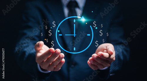 Businessman show virtual icon of clock and money for business time management. Work planning increases efficiency and reduces work time. Time is money concept. photo