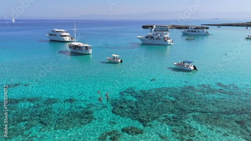 Aerial shot of famous blue lagoon on the island of Cyprus. Clear turquoise water of the Mediterranean Sea and yachts with tourists in the blue lagoon on the west coast of Cyprus photo