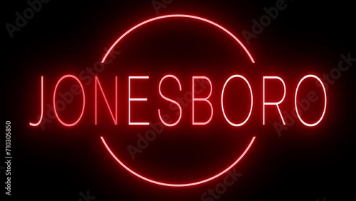 Flickering red retro style neon sign glowing against a black background for JONESBORO photo