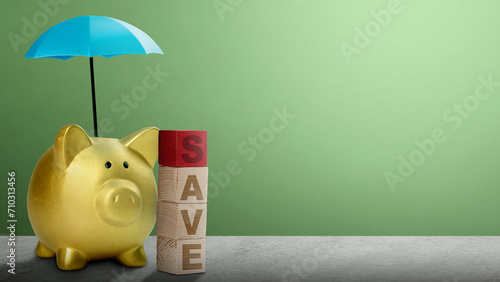 Piggy bank with small blue umbrellas above them and wooden cube with save text