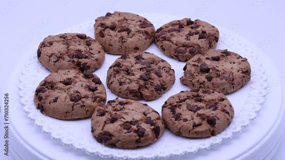Cookies with chocolate chips rotating on a turntable. Cookies with chocolate chips rotating on a turntable.