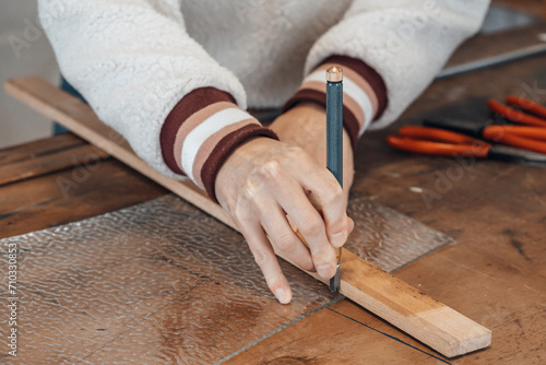 hand of woman master glassmaker at work in a workshop