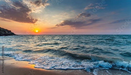 Evening beach, sunset and waves washing the sandy shore. © Євдокія Мальшакова