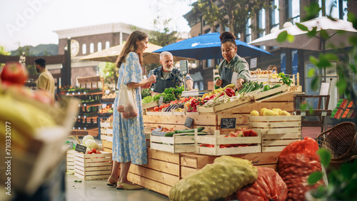 Obraz na plátne Middle Aged Diverse Couple Running a Small Business on a Farmers Market, Selling Organic Fruits and Vegetables