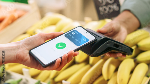 Sustainability-Conscious Consumer Buying Organically Sourced Farm Produce Using a Digital E-Money Software to Pay with Smartphone Through Contactless NFC Technology on a Bank POS Terminal