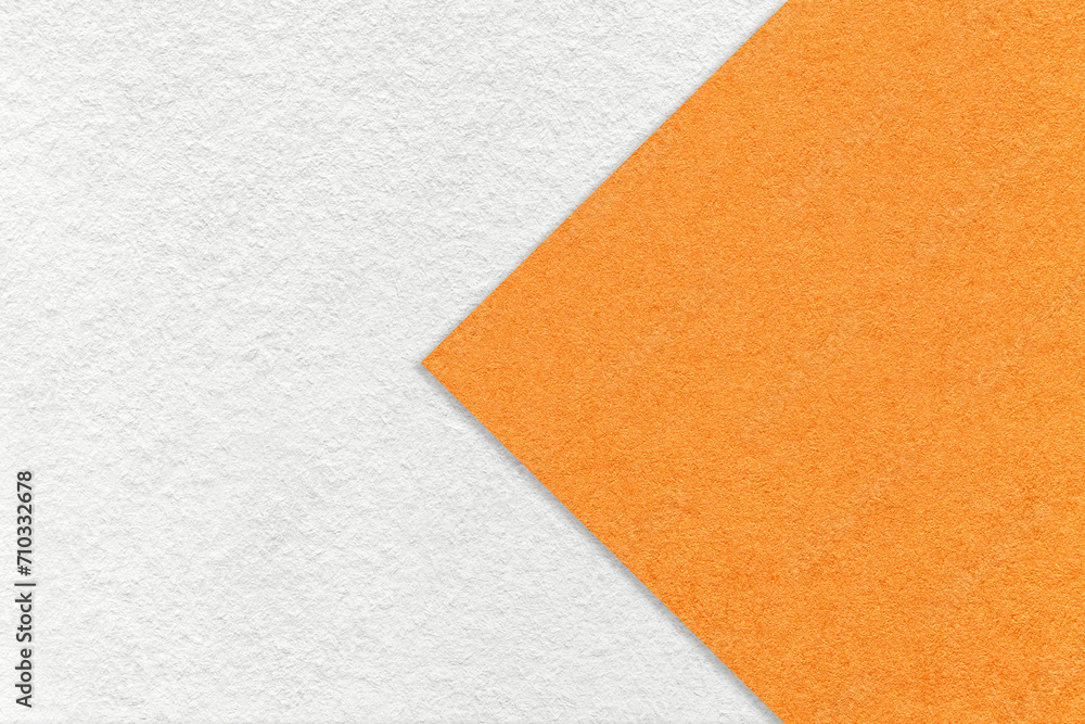 Fototapeta premium Texture of white paper background, half two colors with orange arrow, macro. Structure of dense craft cardboard.