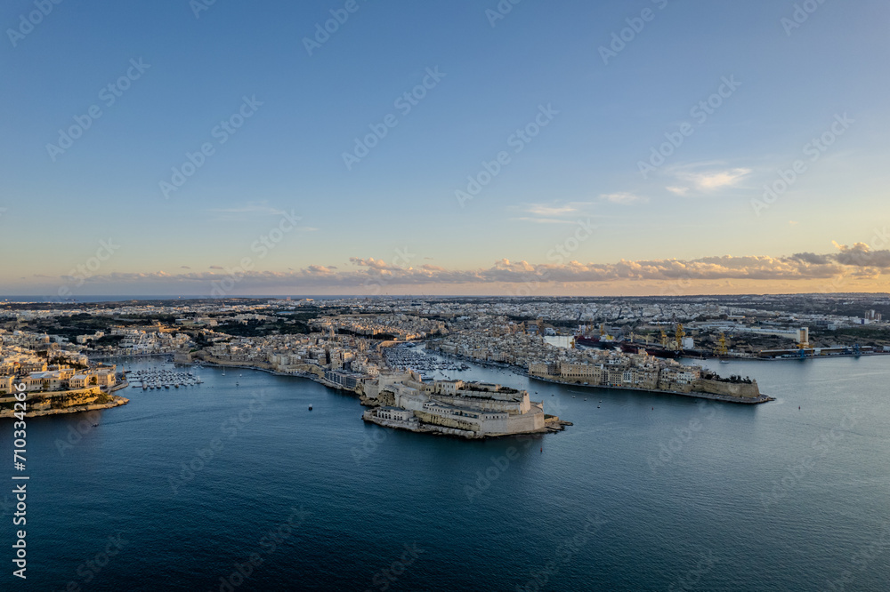 Aerial beautiful drone view of sunset in Valletta old harbour, Malta