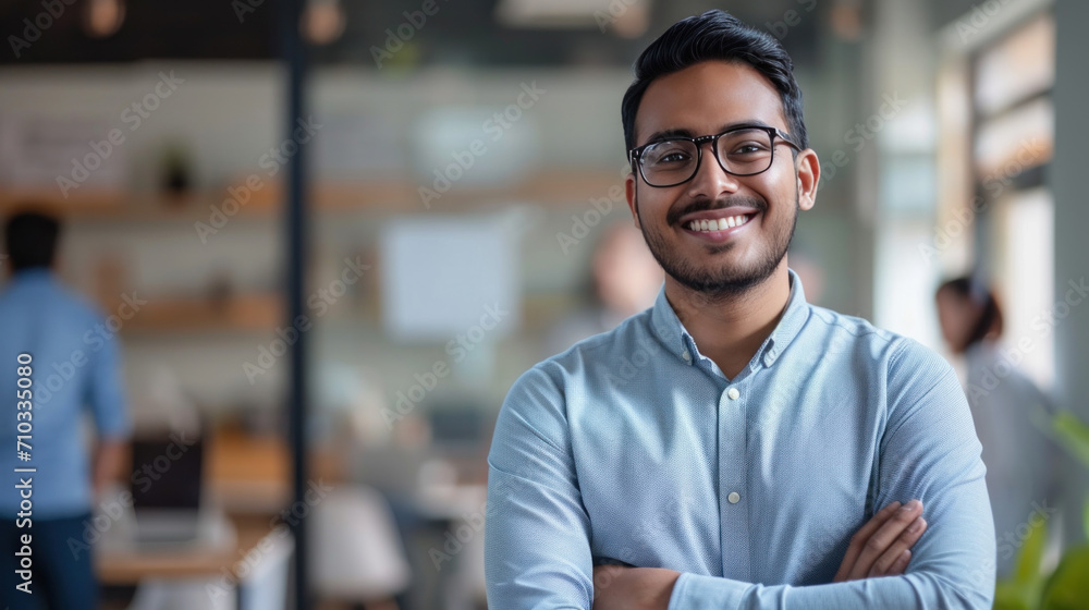 Portrait of a handsome smiling asian indian businessman boss standing in his modern business company office. - obrazy, fototapety, plakaty 