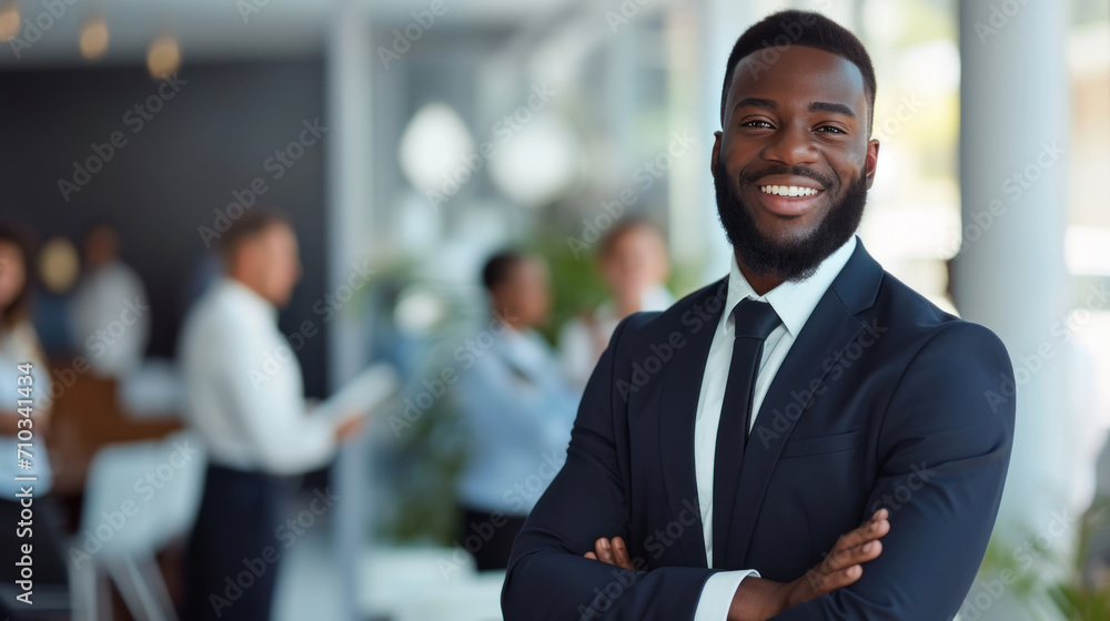 Portrait of a handsome smiling black businessman boss standing in his modern business company office. Portrait of a handsome smiling black businessman boss standing in his modern business company office.