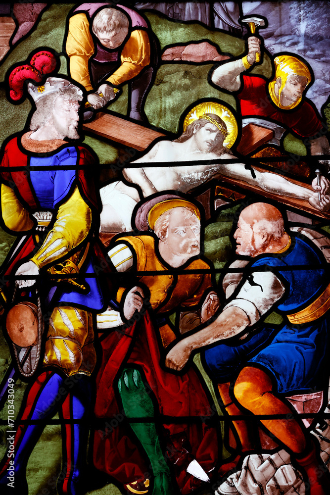 Saint Leonard church. Stained glass. Way of the cross. Station 11. Jesus is nailed to the Cross. Honfleur. France. Saint Leonard church. Stained glass. Way of the cross. Station 11. Jesus is nailed to the Cross. Honfleur. France.