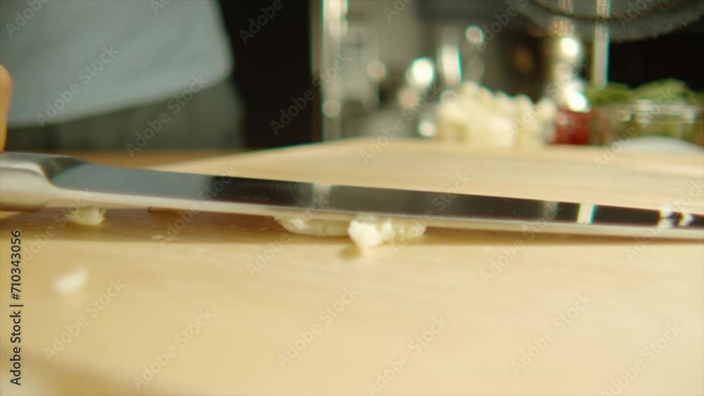 4k Slow Motion close up knife crush and smash garlic on cutting board 4k Slow Motion close up knife crush and smash garlic on cutting board