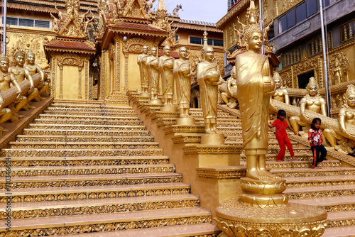 Mongkol Serei Kien Khleang Pagoda.  Staircase decorated with golden Buddhist statues. Phnom Penh; Cambodia. photo