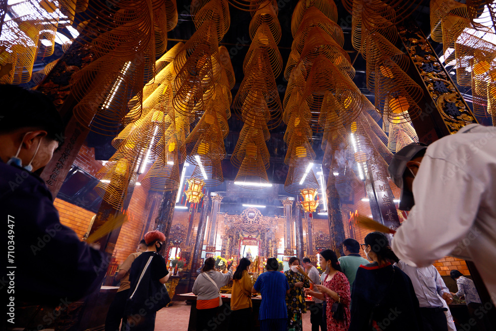 Canton Assembly Hall of Can Tho.  Buddhist believers praying with incense sticks.  Can Tho. Vietnam.